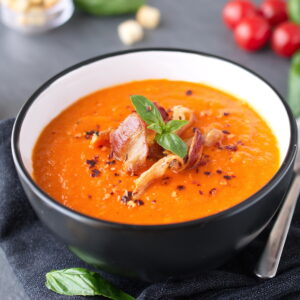 Thick tomato soup with basil and fried beco