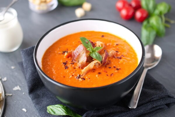 Thick tomato soup with basil and fried beco